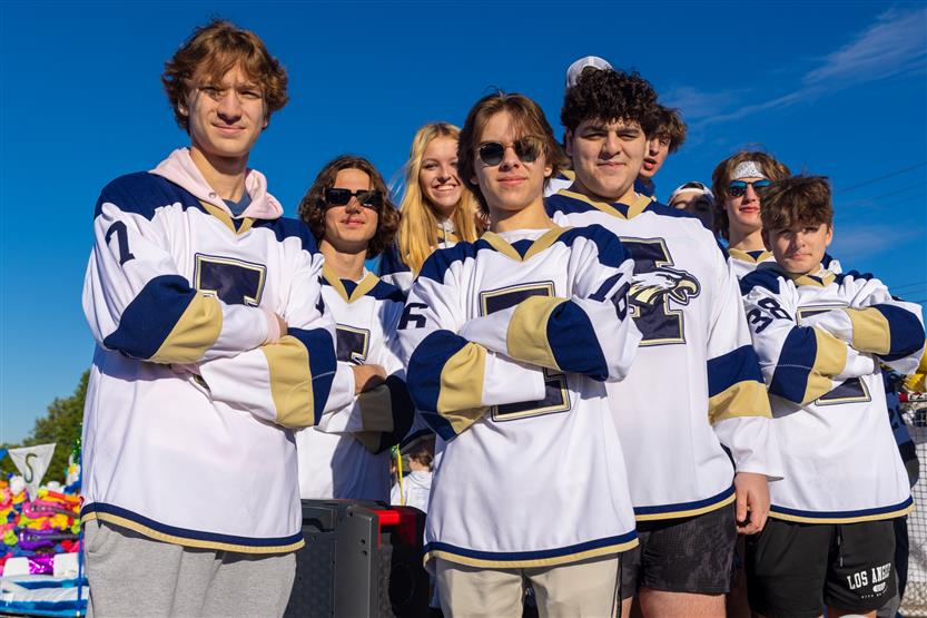 Students ride on a homecoming parade float